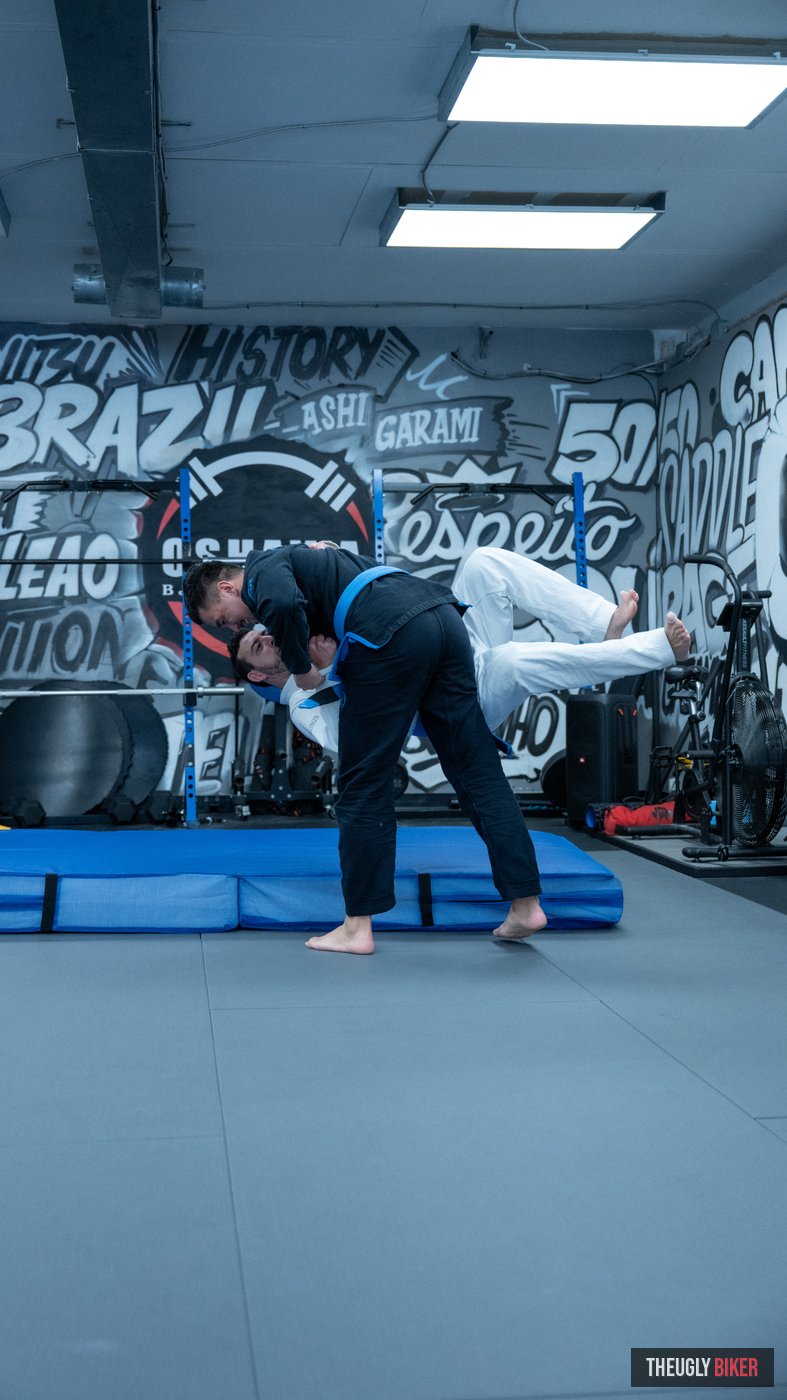 BJJ training in front of gym mural